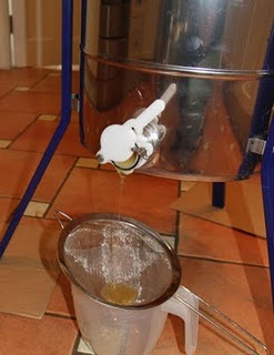 Honey pouring out of the extractor